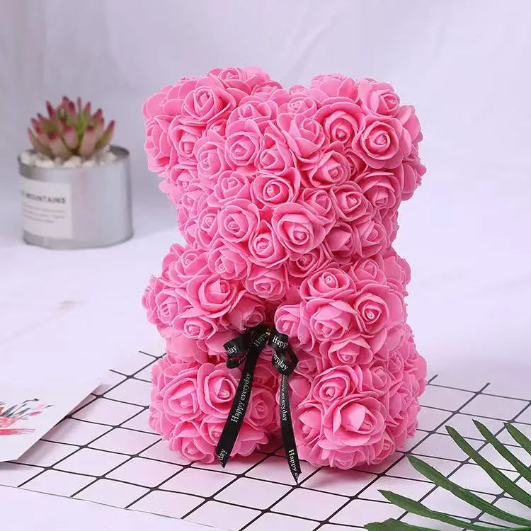 Oso de flor rosa de peluche